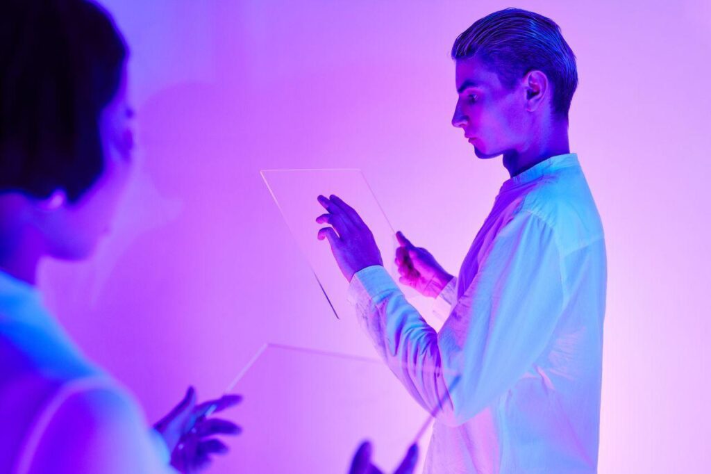 Alt-tag: two people engaging with futuristic transparent touch screens